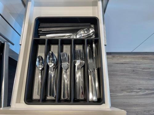 a group of silver utensils in a drawer at Elevator-Work Here-Gig WiFi-King Bed-Laundry in unit in Walnut Creek