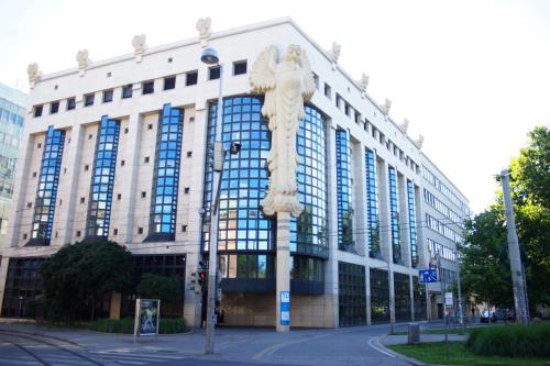 a statue of an angel in front of a building at Drei Kronen Hotel Wien City in Vienna
