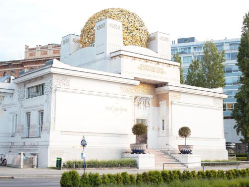 a white building with a large gold dome on top at Drei Kronen Hotel Wien City in Vienna
