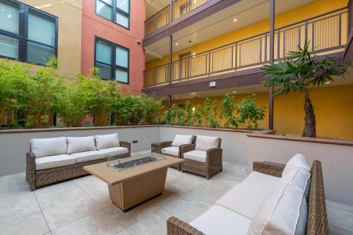 a patio with couches and a table on a building at Elevator-Work Here-Gig WiFi-King Bed-Laundry in unit in Walnut Creek