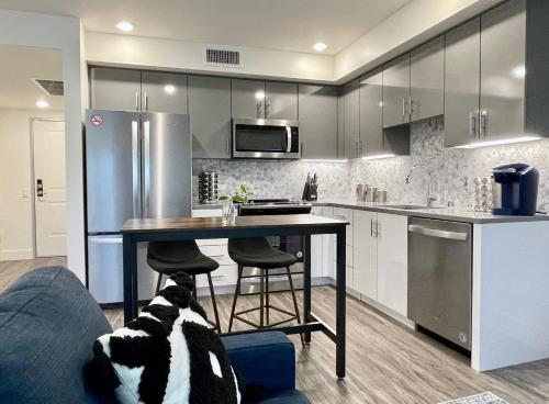 a kitchen with a table and a refrigerator at Elevator-Work Here-Gig WiFi-King Bed-Laundry in unit in Walnut Creek