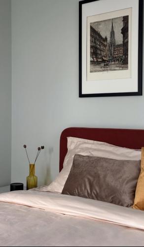 a bedroom with a bed with a picture on the wall at Confetti in Kremenchuk