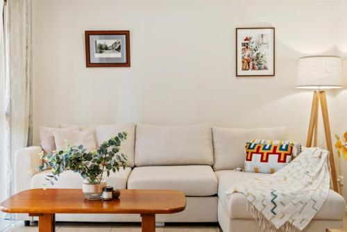 a living room with a couch and a table at Hampton Retreat - South Fremantle Escape in South Fremantle