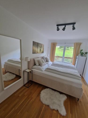 a bedroom with a large bed and a large mirror at Haus Slechta in Jochberg