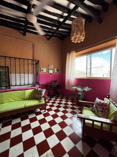 a living room with a couch and a checkered floor at Casona del Negro Aguilar in Valladolid