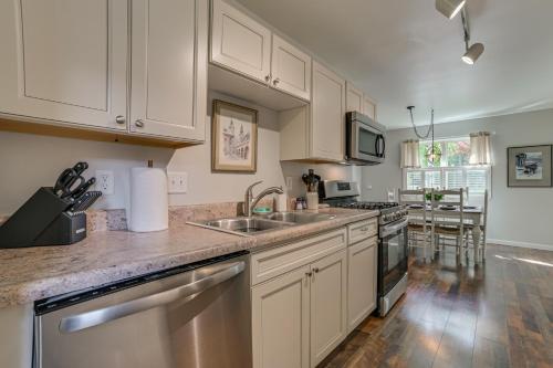 a kitchen with white cabinets and stainless steel appliances at Harbor Springs Winter Retreat about 6 Mi to Skiing! in Harbor Springs