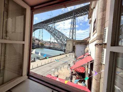 a view of the sydney harbour bridge from a window at Ribeira Cinema Apartments in Porto