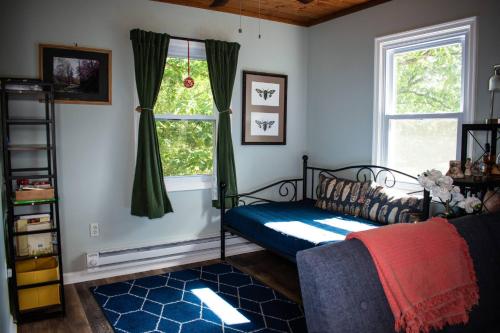 a bedroom with a bed and a window at Cozy Forest Escape with Porch and AC in Lost City