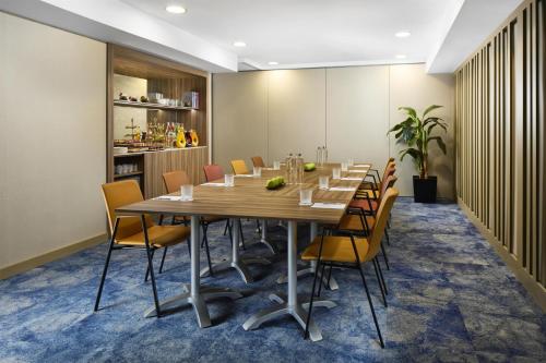 a conference room with a long table and chairs at NH Collection Madrid Colón in Madrid