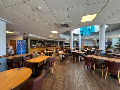 a dining room with tables and chairs in a restaurant at 30, Sunset Terrace in Lytchett Minster