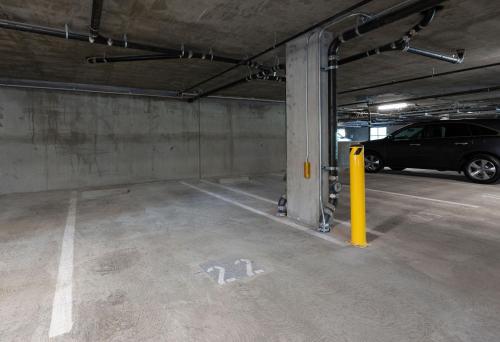 a parking garage with a car parked in it at Bright Top Floor-Elevator-Walk Downtown-Laundry in Walnut Creek