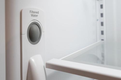 a washing machine in a bathroom next to a sink at Bright Top Floor-Elevator-Walk Downtown-Laundry in Walnut Creek