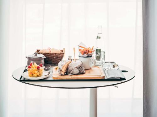 a table with a tray of food on it at Novotel Paris Coeur d'Orly Airport in Orly
