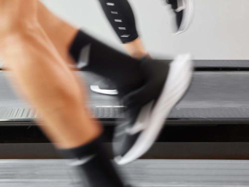 a close up of a woman running on a treadmill at Novotel Paris Coeur d'Orly Airport in Orly