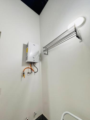 a bathroom with a light fixture on the wall at A unos pasos de la Arena in Puerto Viejo