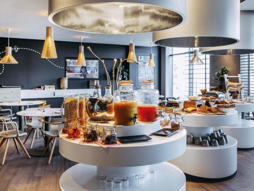 a display of food on tables in a restaurant at Novotel Paris Coeur d'Orly Airport in Orly