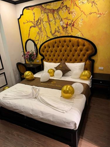 a bedroom with a bed with gold decorations on it at Royal Lotus Hotel in Hanoi