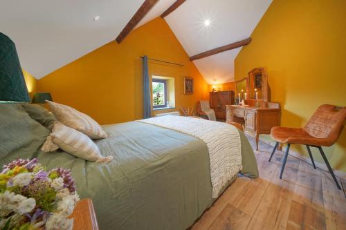 a bedroom with a large bed and a desk at La Forge - Chambres d'hôtes en Ardenne in Wellin