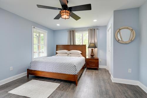 a bedroom with a bed and a ceiling fan at 12 Mi to Downtown Winston-Salem Apt with Balcony! in Thomasville