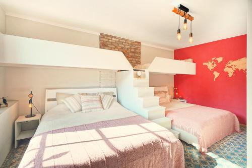 a bedroom with a white bed and a red wall at La Forge - Chambres d'hôtes en Ardenne in Wellin