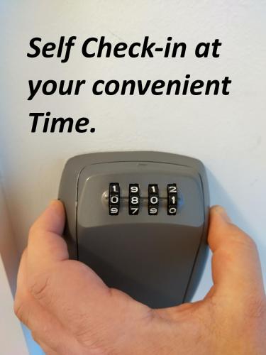 a person holding a remote control in their hand at Aparthotel Neudörfl in Neudörfl