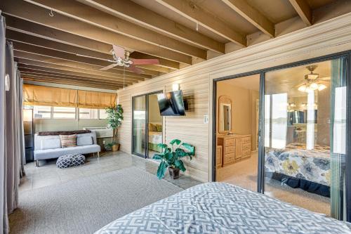 a bedroom with a bed and a couch and a tv at Boat Slip and Pool Access at Lake Ozark Condo! in Lake Ozark