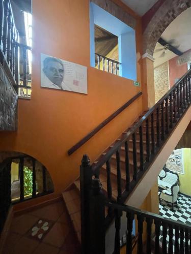 a staircase in a house with a painting on the wall at hotel san nicolas colonial in Barranquilla