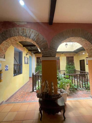 a room with an archway in a building at hotel san nicolas colonial in Barranquilla