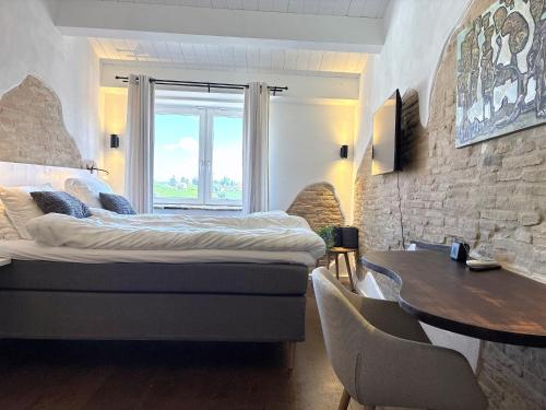 a bedroom with a large bed and a table at Charming Boutique B&B Hotel in Villalfonsina