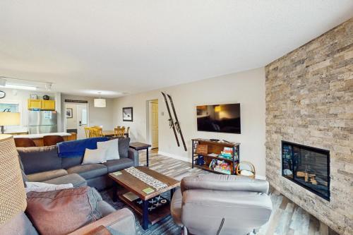 a living room with a couch and a fireplace at Big Horn 3 in Big Sky