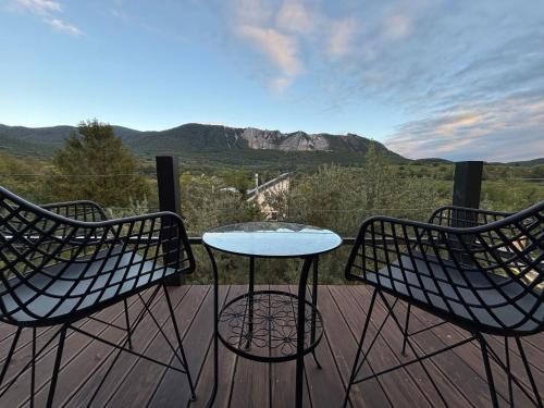 two chairs and a table on a deck with a view at My Wood Cabin - Mokka in Bélapátfalva