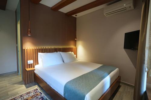 Ein Bett oder Betten in einem Zimmer der Unterkunft Palorto Hotel