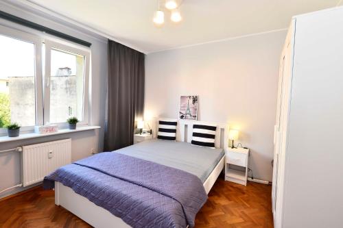 a bedroom with a bed and a window at Amber room in Sopot