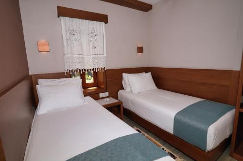 Ein Bett oder Betten in einem Zimmer der Unterkunft Palorto Hotel