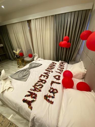 a bedroom with a bed with red decorations on it at Inside Pyramids Inn in Banī Ghālib