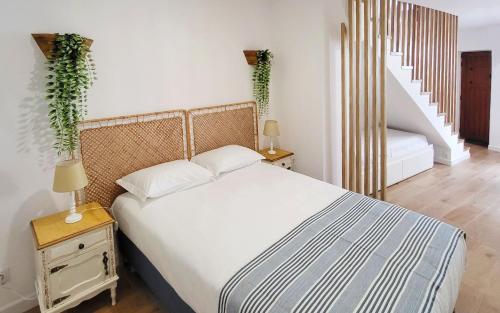 a bedroom with a large bed and a staircase at Casa Miradouro das Beatas in Elvas