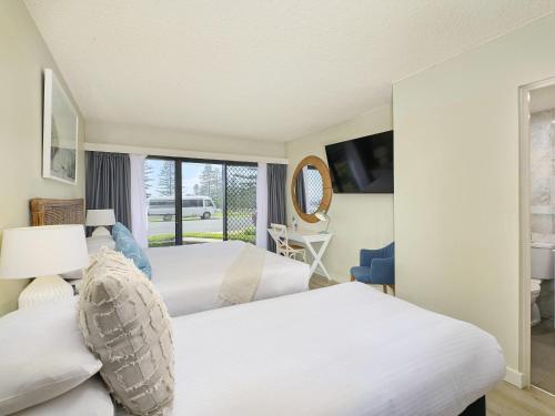 a hotel room with two beds and a window at ibis Styles Port Macquarie in Port Macquarie