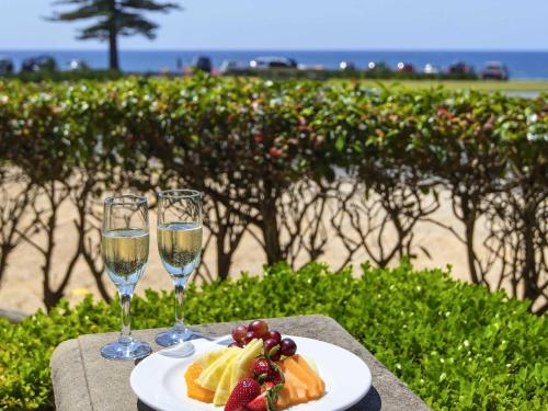 a plate of food and two glasses of wine at ibis Styles Port Macquarie in Port Macquarie