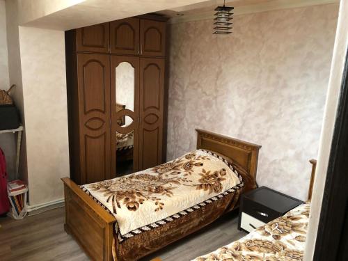 a bedroom with a bed and a large mirror at Full Apartment in Yerevan