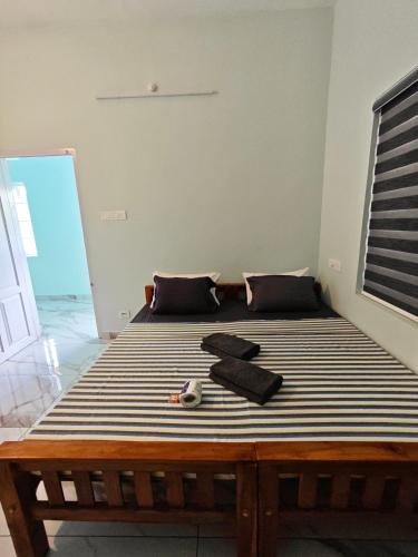 a bedroom with a large bed with a wooden frame at Happy Buddha Varkala in Varkala