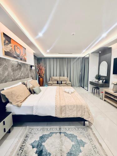 a bedroom with a large bed and a living room at Crystal Luxury Studio At Kass 1000 in Accra