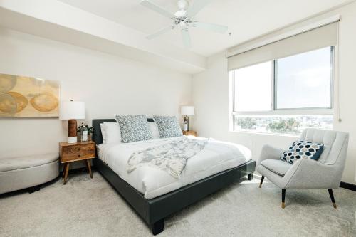 a bedroom with a bed and a chair and a window at Stylish Vibes 1BD in WEHO in Los Angeles