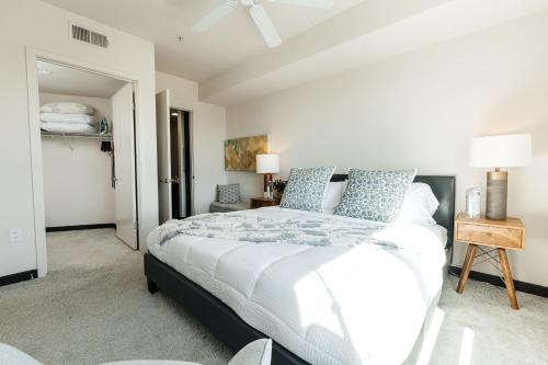 a bedroom with a large white bed with blue pillows at Stylish Vibes 1BD in WEHO in Los Angeles