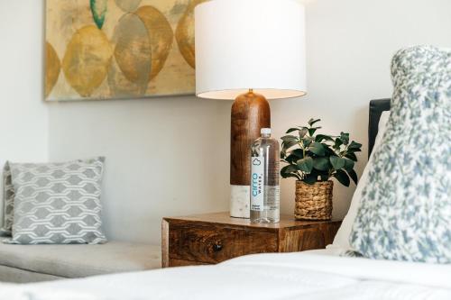 a bedroom with a bedside table with a lamp and a couch at Stylish Vibes 1BD in WEHO in Los Angeles