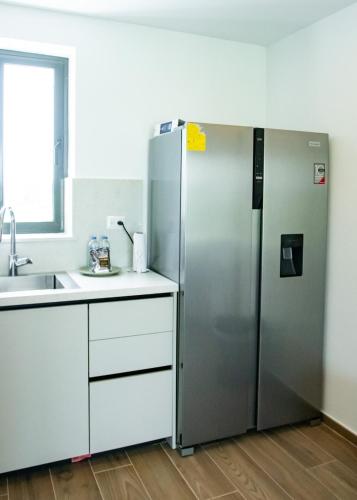 a stainless steel refrigerator in a kitchen with a sink at Cana Cove in Punta Cana