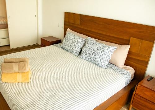 a bedroom with a large bed with a wooden headboard at Cana Cove in Punta Cana