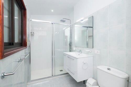 a bathroom with a shower and a toilet and a sink at Casa Blanca, Golf Del Sur in San Miguel de Abona