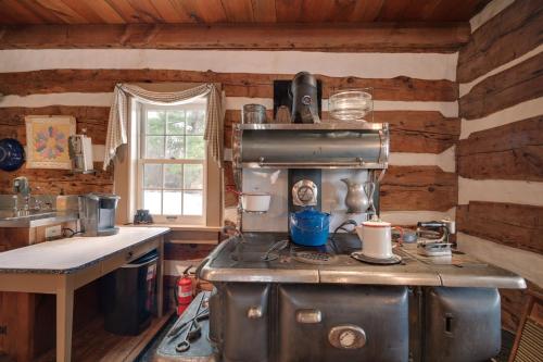 a kitchen with a stove top oven in a cabin at Cabin Vacation Rental about 8 Mi to Penn State! in State College
