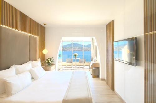 a hotel room with a bed and a view of the ocean at Hôtel Marinca & Spa in Olmeto
