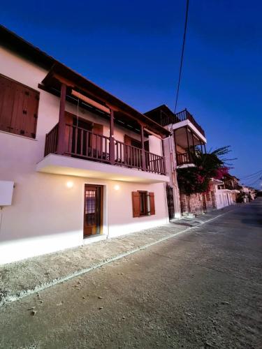 a white building on the side of a street at Armiriki Seafront House in Afissos